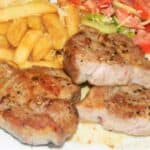 Pork Steak With Fries and Vegetable Salad-Served on Plate