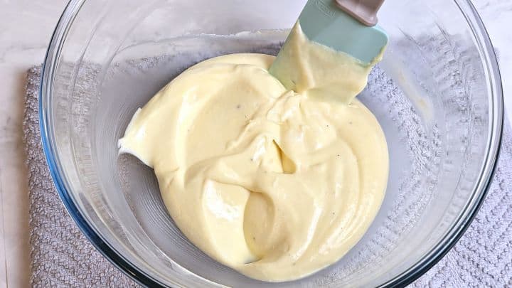 Smooth, velvety homemade mayonnaise and sour cream dressing mixed together in a bowl.