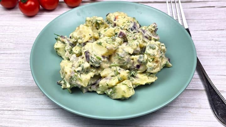 Best potatoes Salad-With Homemade Mayonnaise Cold potato salad with sour cream and mayo dressing served on a plate with a fork.