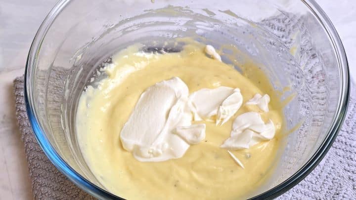 Adding a spoonful of cool sour cream over fresh homemade mayonnaise.