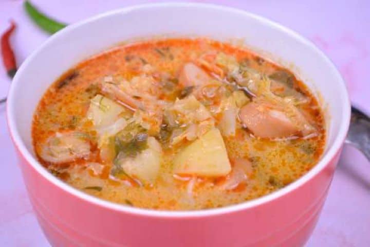 Served Savoy Cabbage Soup with Frankfurters Served in Bowl With Chilly Peppers