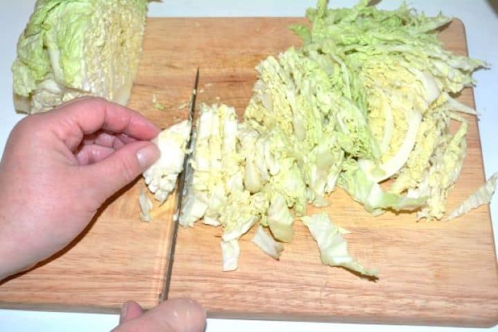 Slicing Cabbage Slicing the Savoy Cabbage on the Cutting Board