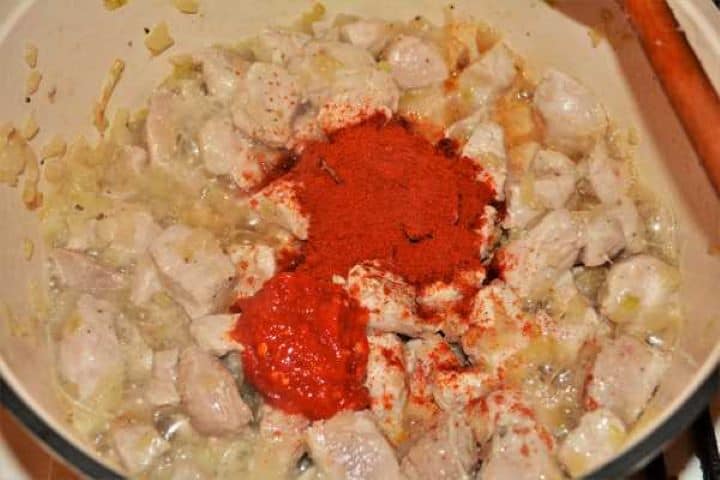 Cabbage Soup With Pork Meat-Add Paprika Powder and Paprika Cream on the Fried Pork Meat in the Pot Adding sweet Hungarian paprika powder and crushed paprika cream to seared pork meat.