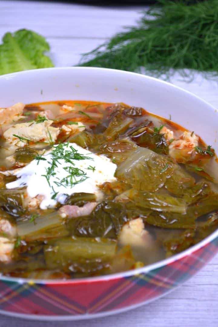 Transylvanian Lettuce Soup Served in Bowl With Sour Cream