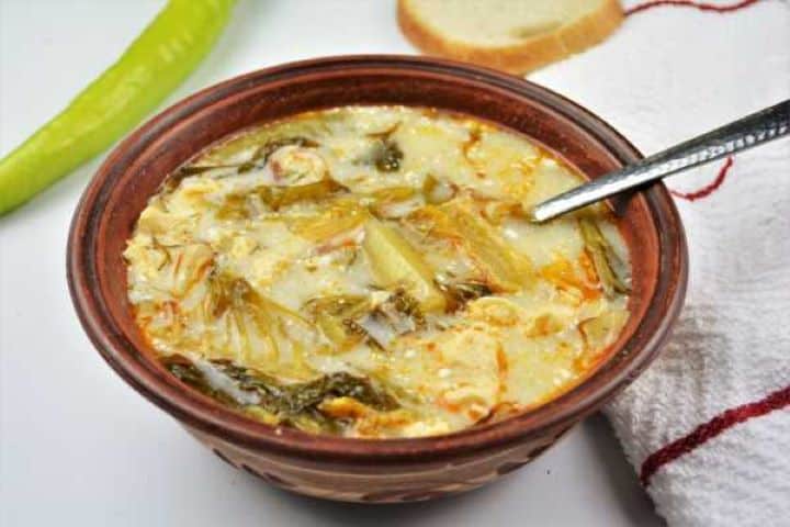 Romaine Lettuce Soup Recipe-Served in Bowl With Sour Cream Transylvanian Lettuce Soup Served in the Ceramic Bowl With Sour Cream on Top