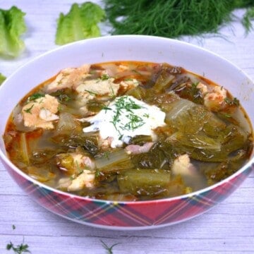 Transylvanian Lettuce Soup Served in the Bowl With Sour Cream on Top