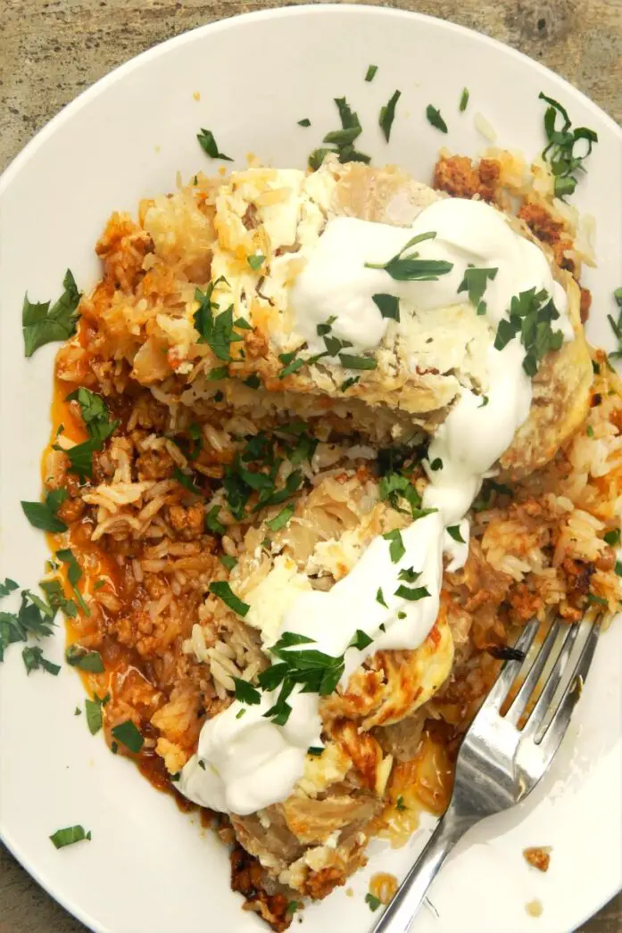Cabbage Casserole Recipe-Served on Plate With Sour Cream on Top