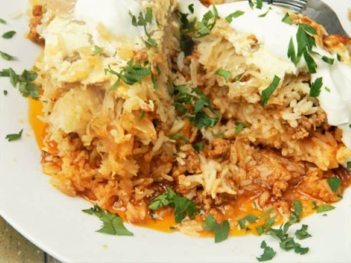 Cabbage Casserole Recipe-Served on Plate With Sour Cream on the Top Cabbage Casserole Served on Plate
