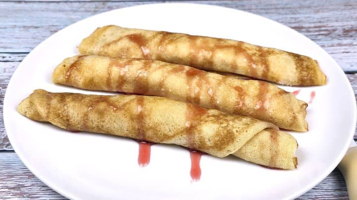Cottage Cheese Filled Crepes Served on White Plate