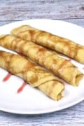 Three Cottage Cheese Filled Crepes Served on White Plate