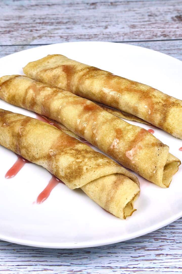 Cottage Cheese Filled Crepes Served on Plate