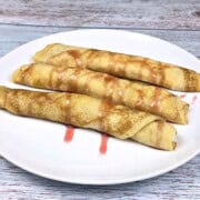 Three Cottage Cheese Filled Crepes Served on White Plate