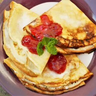 Cream Cheese Filling Crepes-Served on Plate With Raspberry Jam on Top