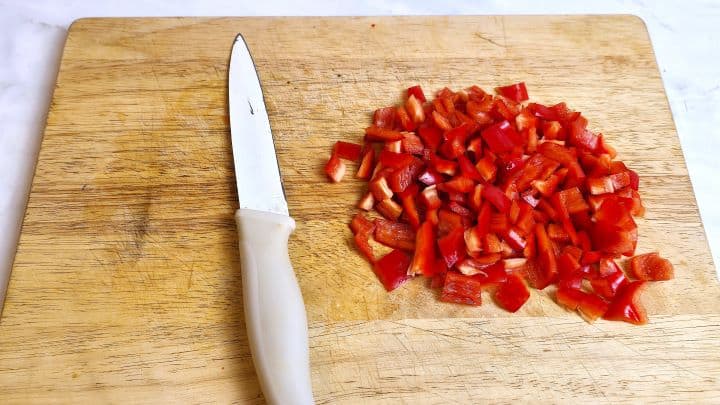 Best Homemade Beef Stew Recipe-Red Sweet Pepper Cut in Small Pieces Chopped Red Pepper on Cutting Board