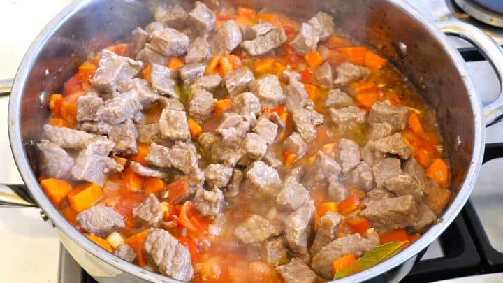 Best Homemade Beef Stew Recipe-Fried Beef Meat and Vegetables in a Pot Fried Meat on Sauteing Vegetables in the Pan