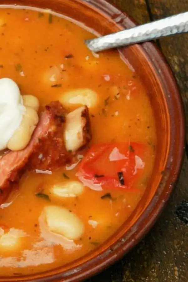 White Bean Soup With Smoked Ribs-Served in Bowl With a Spoon of Sour Cream