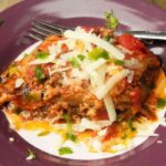 Best Eggplant Casserole Recipe-Served on Plate With Grated Cheddar on Top