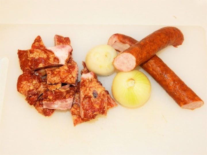 Smoked Ribs, Sausage and Onions Ingredients for Hungarian sauerkraut soup including raw chopped onions, high quality smoked pork sausages, and bone-in pork ribs.