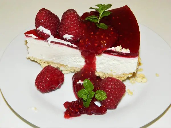 Best Raspberry Cheesecake Recipe-Cheesecake Slice on the Plate With Raspberry Jam on the Top