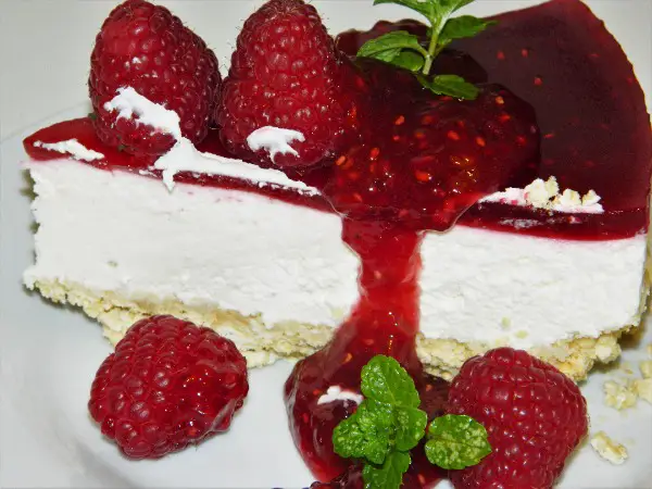Best Raspberry Cheesecake Recipe-Cheesecake Slice on the Plate With Raspberry Jam on the Top