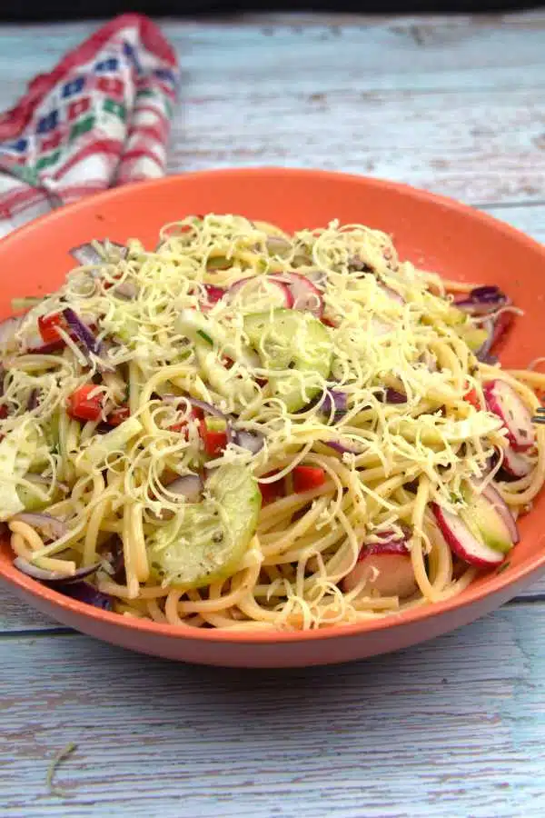Best Spaghetti Salad Recipe-Served in an Orange Bowl With Grated Cheddar