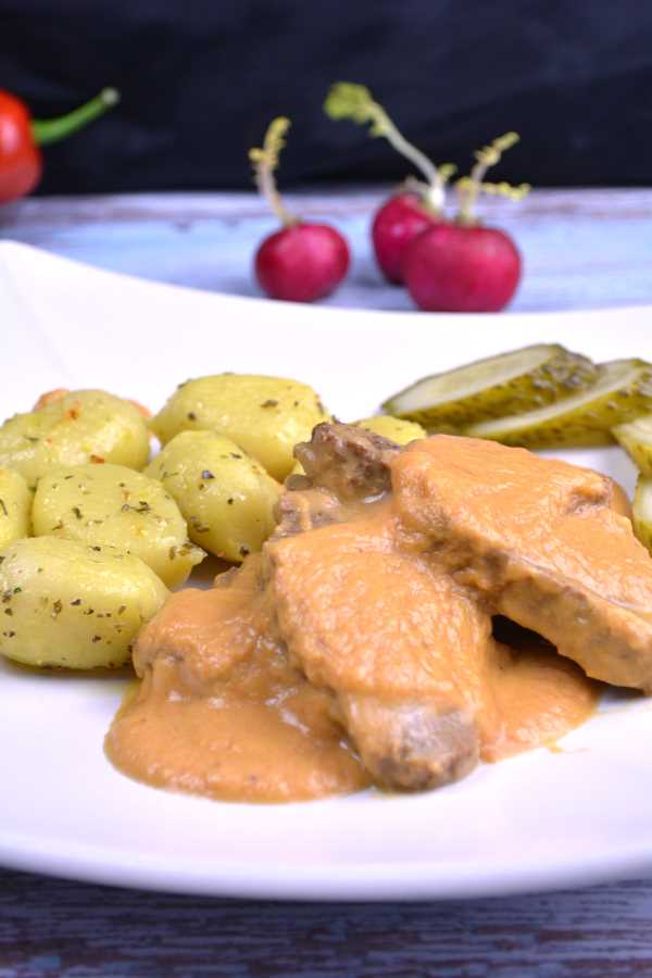 Hungarian Hunter's Stew Recipe-Served on Plate With Gnocchi and Pickles