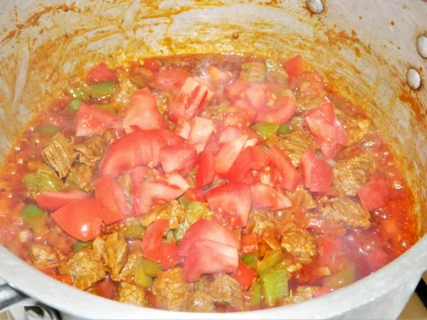 Traditional Hungarian Goulash Recipe-Add Cut Tomatoes Over the Frying Meat and Peppers