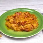 Vegetable Stew With Eggs Served on Plate With Two Bread Slices