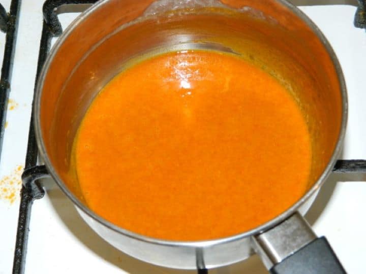 Mixing sweet Hungarian paprika powder into the warm flour paste off the heat until smooth.