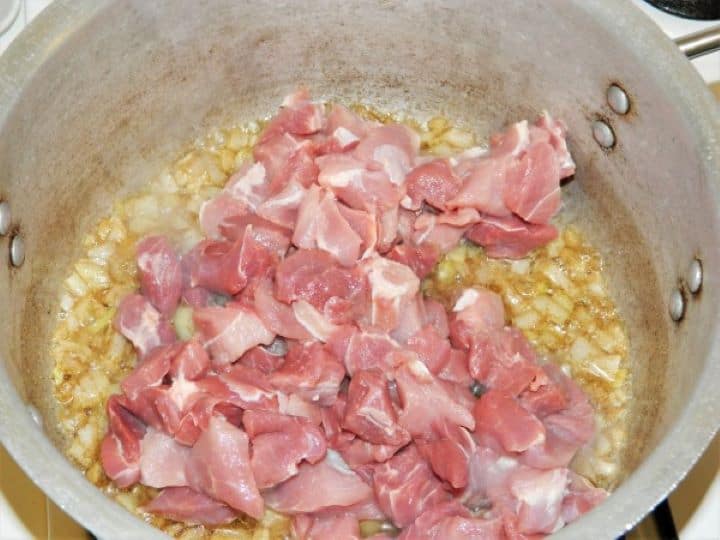 Diced Pork Meat on Frying Onions in the Pot