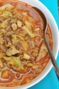 Traditional Hungarian cabbage soup with pork meat, beautifully marbled with a generous swirl of cold sour cream.