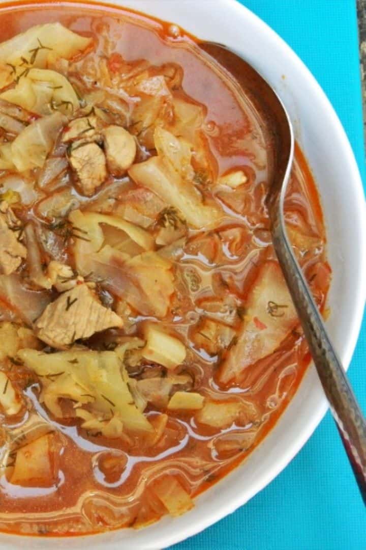 Traditional Hungarian cabbage soup with pork meat, beautifully marbled with a generous swirl of cold sour cream.