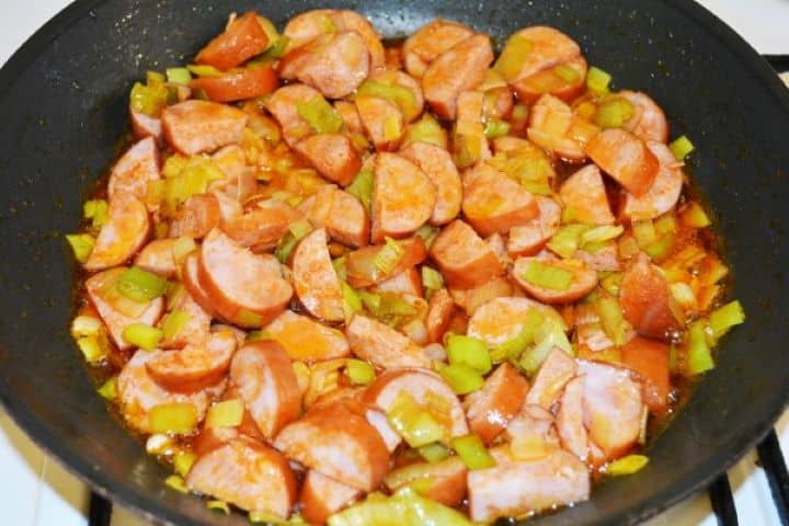 Best Cheesy Potato Casserole Recipe-Frying Sausage and Chopped Leaks Frying Sausage and Chopped Leek in the Pan