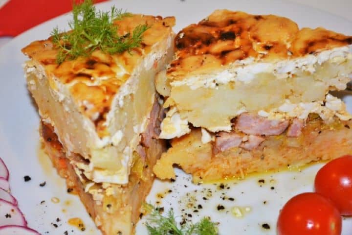 Best Cheesy Potato Casserole Recipe-Served on Plate With Cherry Tomatoes Cheesy Hungarian Rakott Krumpli Served on Plate With Cherry Tomatoes