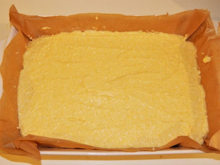 Unbaked sweet cornmeal cake leveled in a baking tray ready for the oven.