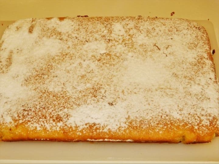 Hot sweet cornbread dusted generously with powdered icing sugar.