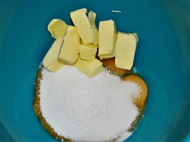 Egg yolks, butter, and sugar in a mixing bowl.
