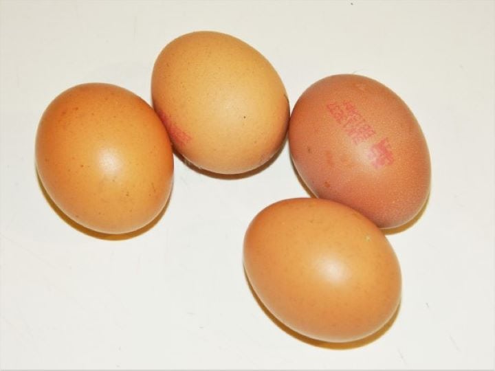 Four whole fresh eggs ready to be separated.