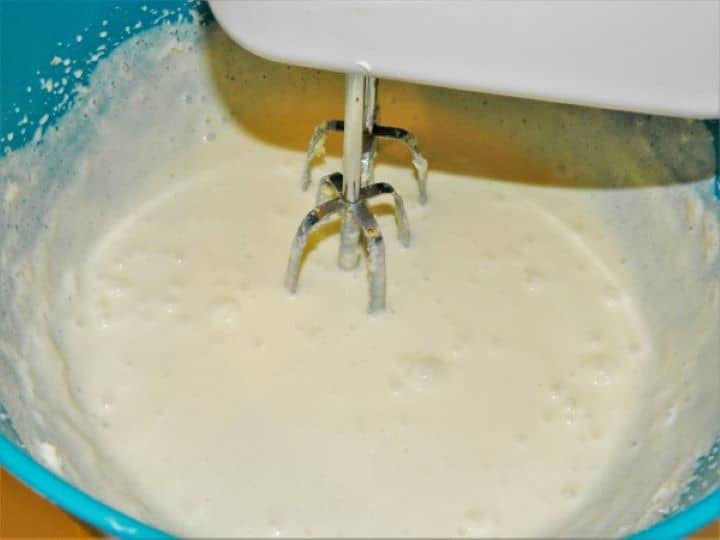Mixing Greek yogurt into the butter and egg yolk batter.