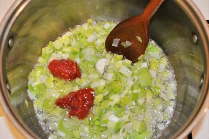 Best Turkey Stew Recipe-Add Paprika Paste on Frying Chopped Leak Sliced green and white leeks sautéing in sunflower oil in a large stockpot, mixed with brilliant red Hungarian sweet paprika powder.
