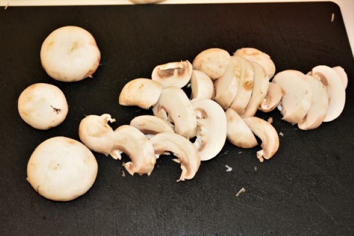 Best Turkey Stew Recipe-Slicing Mushrooms Sliced White Mushrooms on the Cutting Board