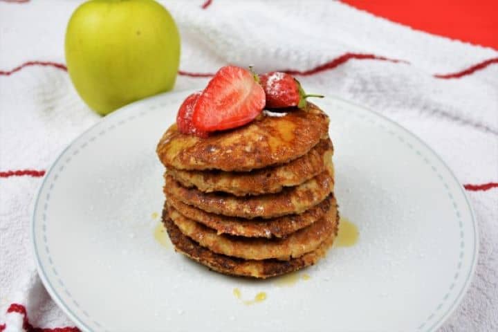 Easy Cinnamon Apple Pancakes Recipe-Served on Plate With Maple Syrup and Strawberry Easy Fluffy Cinnamon Apple Pancakes Served on Plate With Maple Syrup and Strawberries on Top