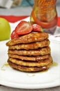 Easy Cinnamon Apple Pancakes Served on Plate With Maple Syrup and Strawberries
