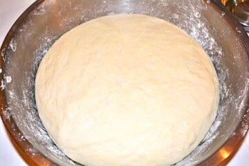 Yeast dough for Hungarian fried bread doubled in volume after proofing