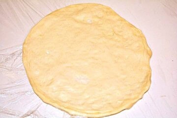 How to stretch Hungarian Langos dough by hand for a thin center and puffy edges