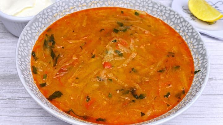 Creamy Kohlrabi Soup Served in Bowl With Sour Cream and Lemon