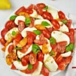 Tomatoes Caprese Salad Recipe-Served on Plate With Basil and Mozzarella