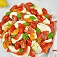 Tomatoes Caprese Salad Recipe-Served on Plate With Basil and Mozzarella