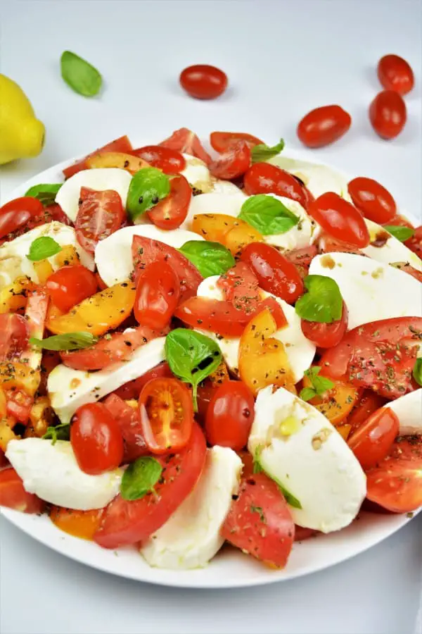Tomatoes Caprese Salad Recipe-Served on Plate With Basil and Mozzarella