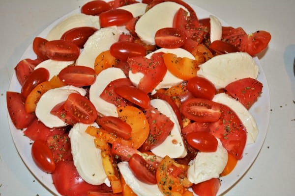 Tomatoes Caprese Salad Recipe-Sliced Mozzarella and Red and Yellow Tomatoes on the Plate